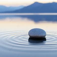 Hypnose Ruhe Ein glatter Stein liegt auf der Wasseroberfläche, umringt von sanften Wellen.