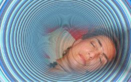 Eine schlafende Frau mit einem hypnotischen, kreisförmigen Muster um sie herum.
